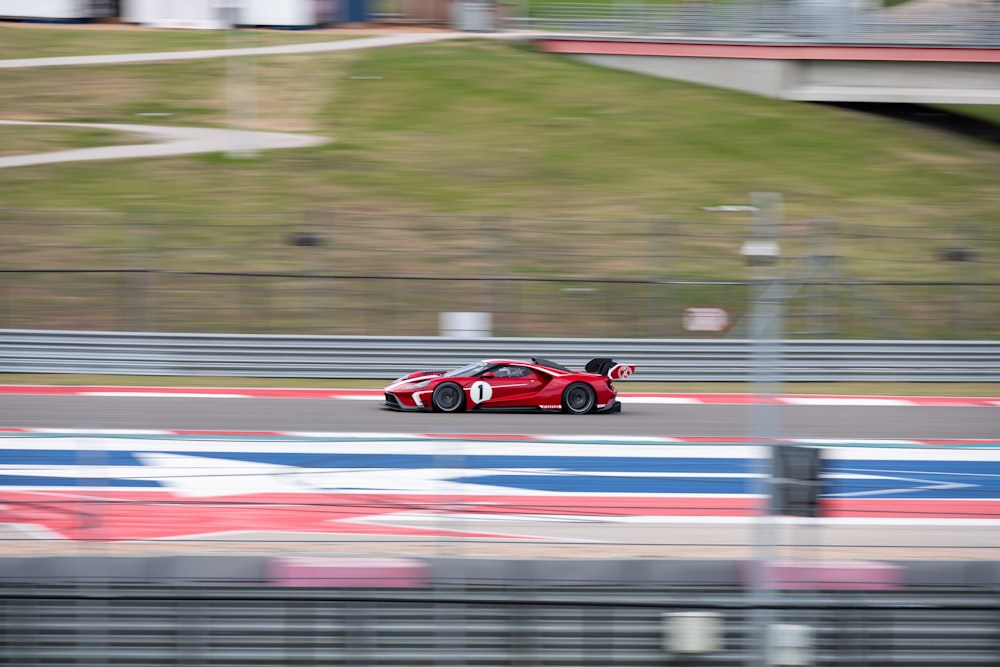 red ferrari f 1 on road during daytime