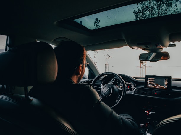 woman driving car during daytime