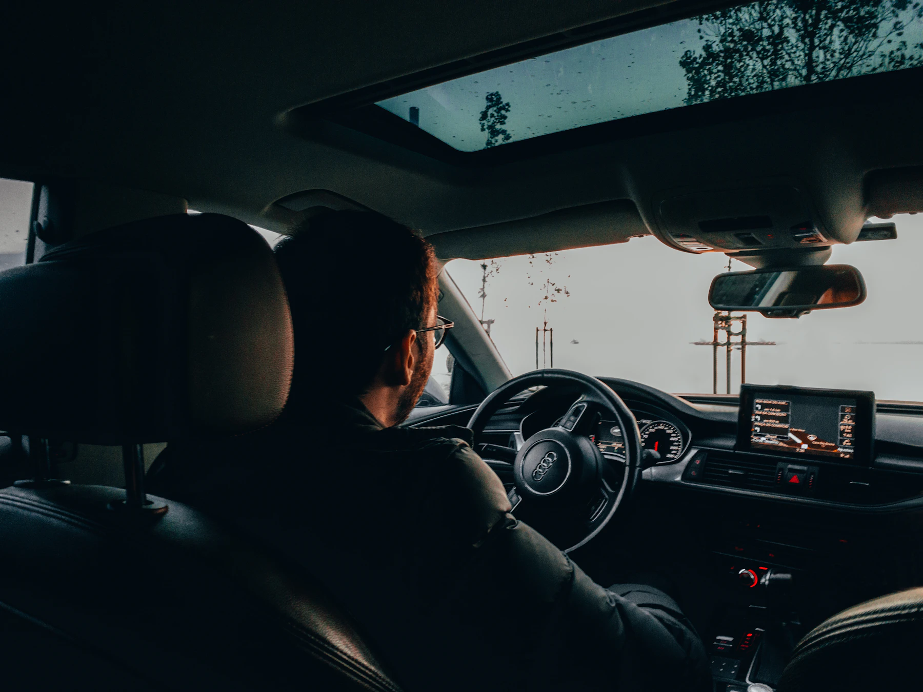 Driver seated comfortably inside a modern vehicle cabin