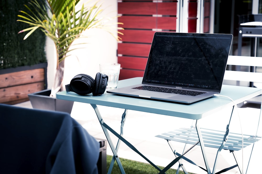 black laptop computer on white table