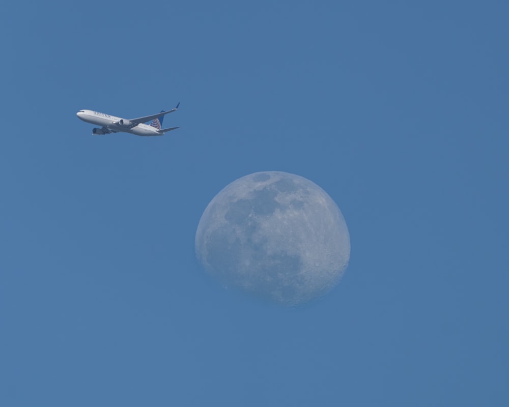 Weißes Flugzeug, das tagsüber am Himmel fliegt