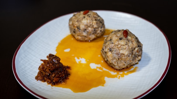 Close-up of a freshly prepared teriyaki chicken rice ball with sesame seeds on top.