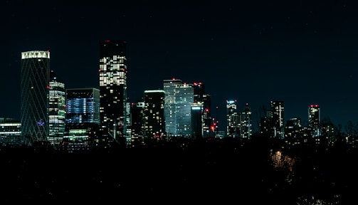 Elegant city skyline at night with illuminated skyscrapers.