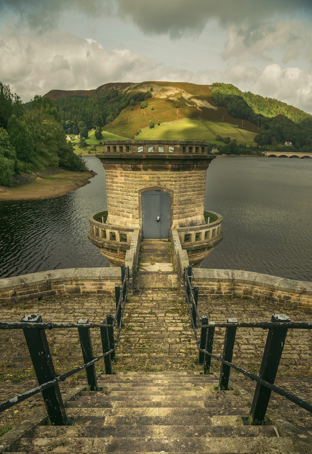 brown concrete stairs on body of water