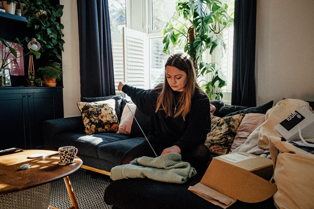 woman in black long sleeve shirt sitting on couch