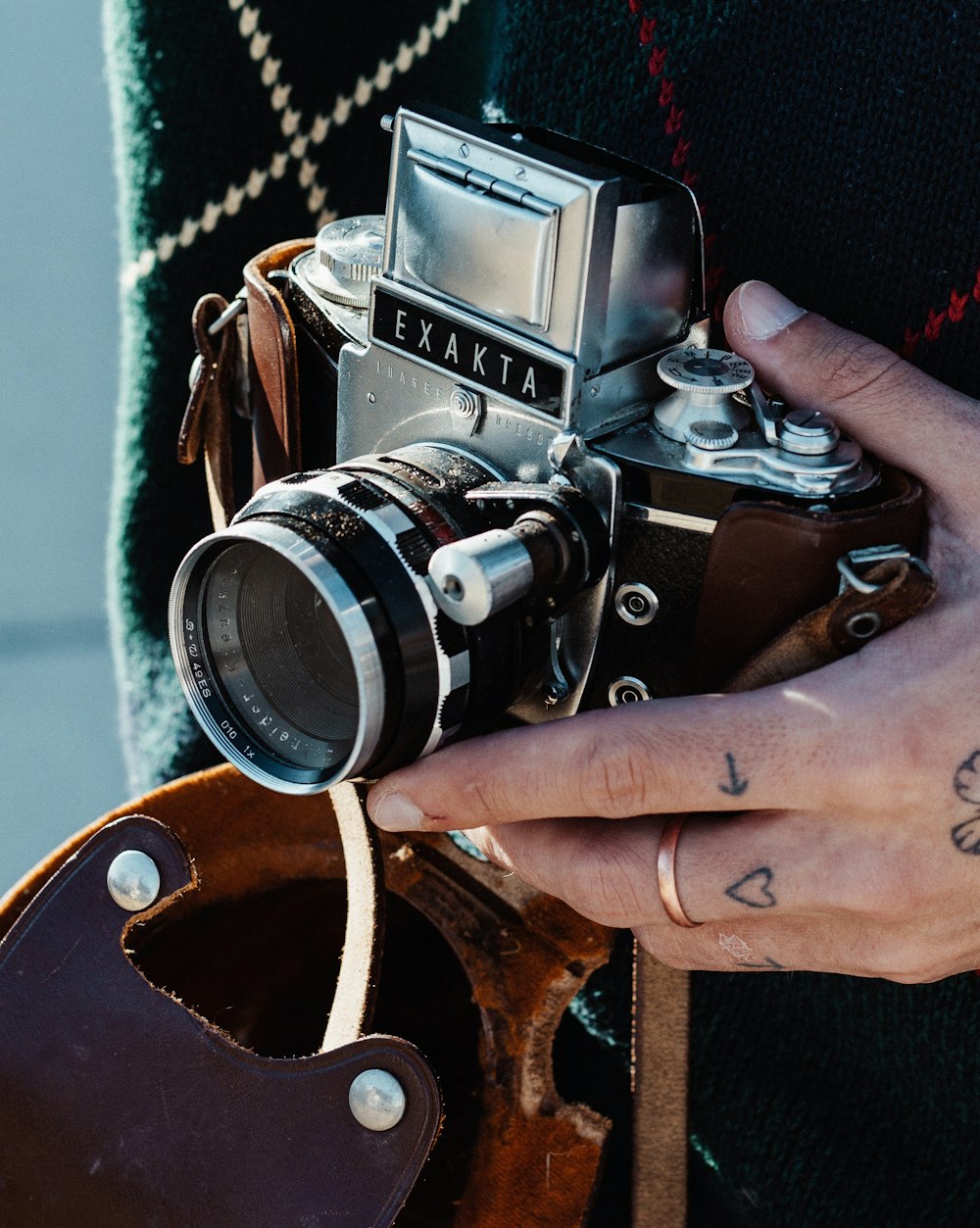 person holding black and silver dslr camera