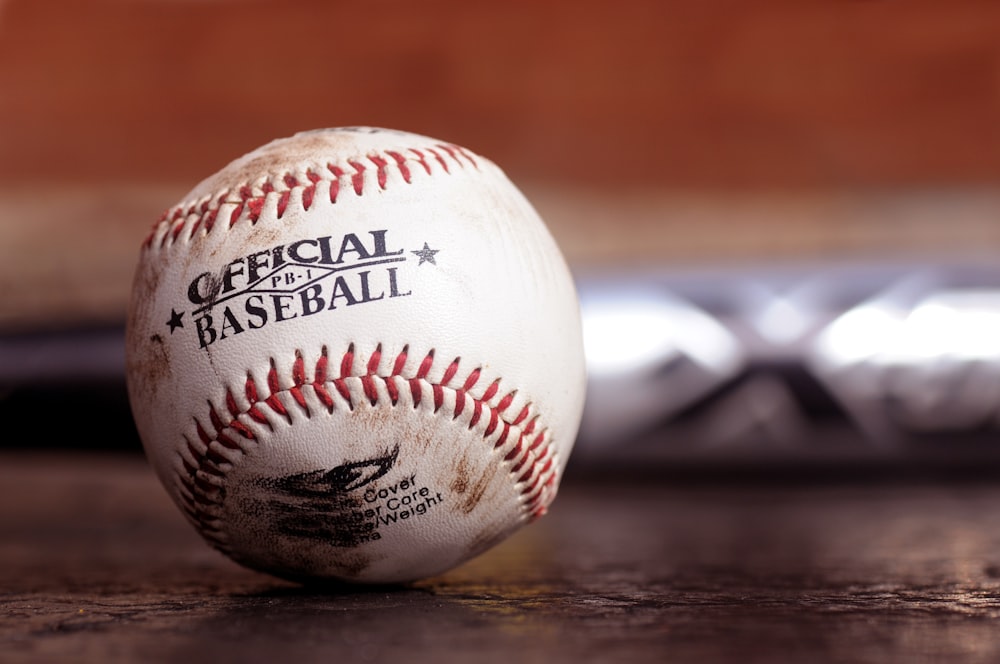 white and red baseball on black table