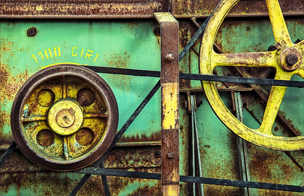 yellow and black wheel on green metal fence