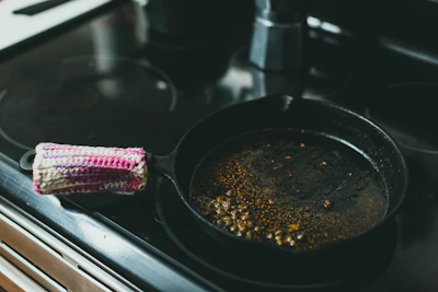 Wiping excess oil off a pan with paper towel