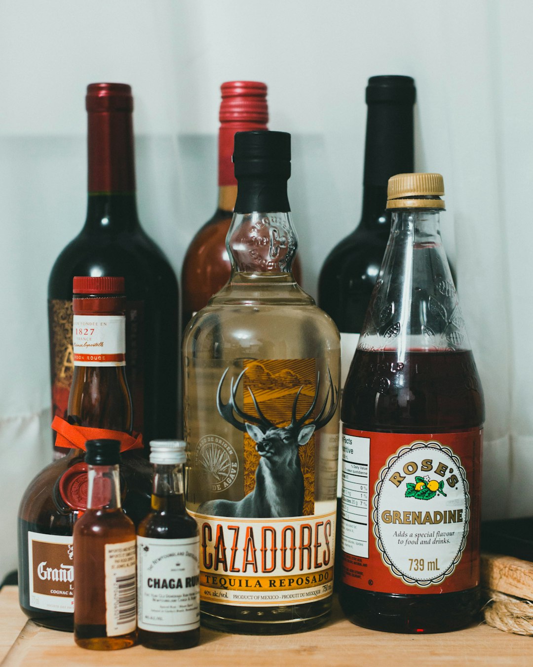 assorted label bottles on white shelf