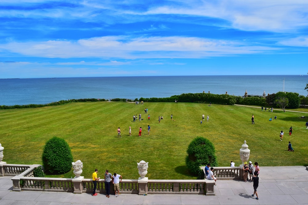 people walking on green grass field during daytime