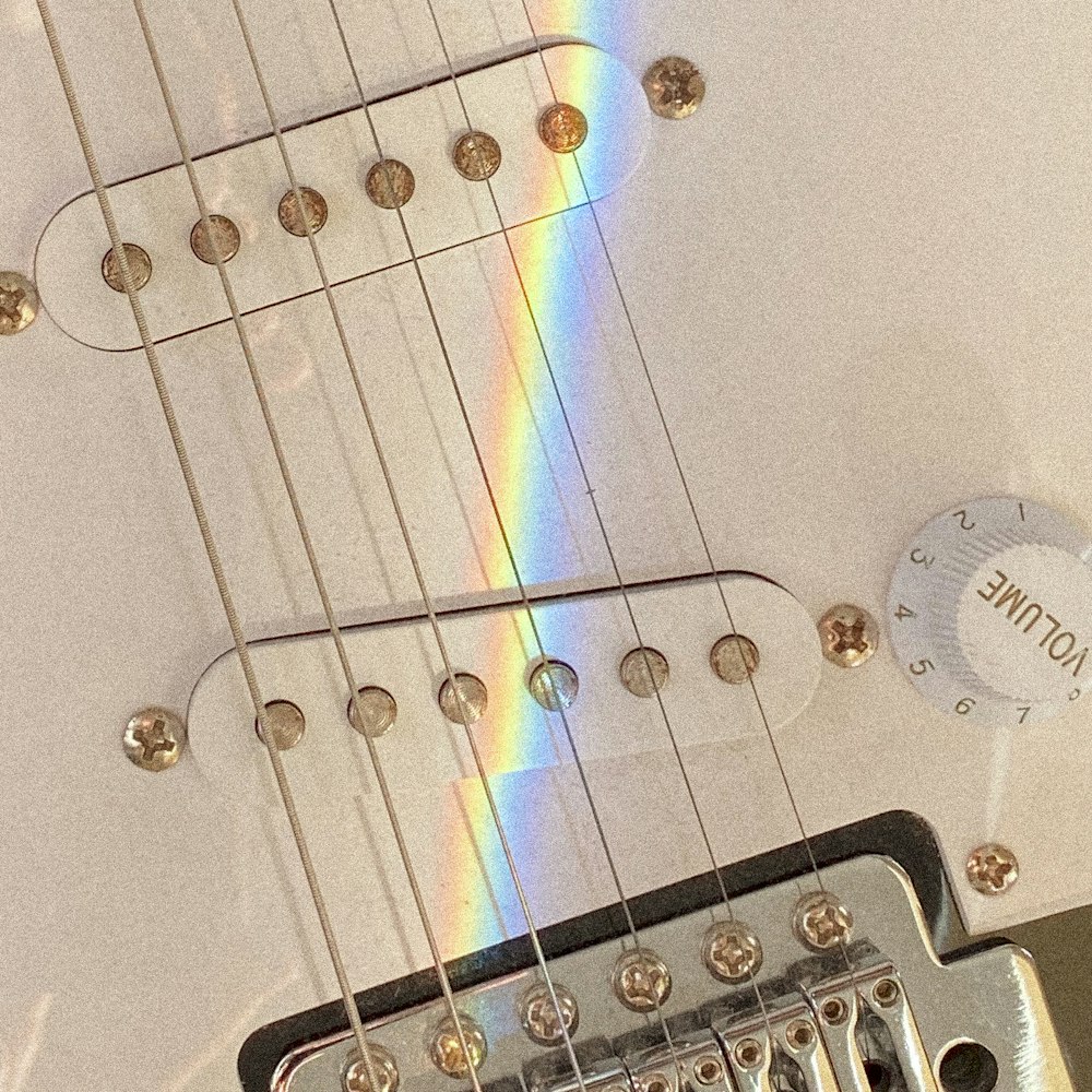 white electric guitar with purple string lights