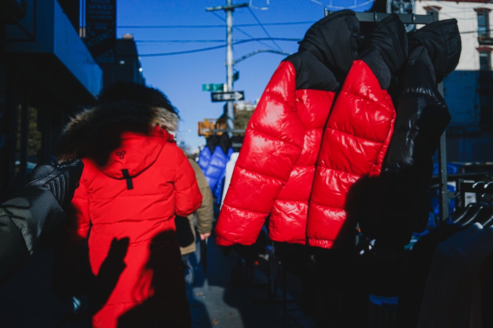 people in blue jacket walking on street during daytime