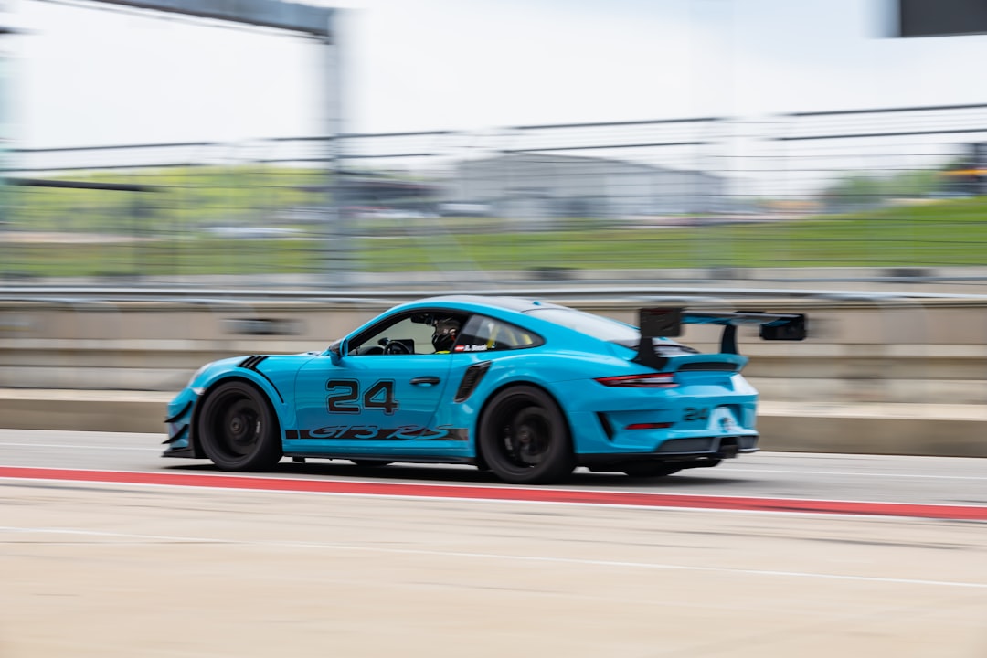 blue and black racing car on track during daytime