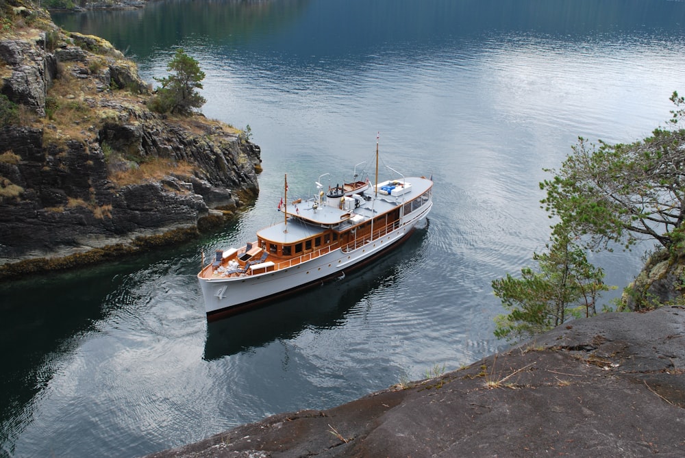 white and black boat on water during daytime