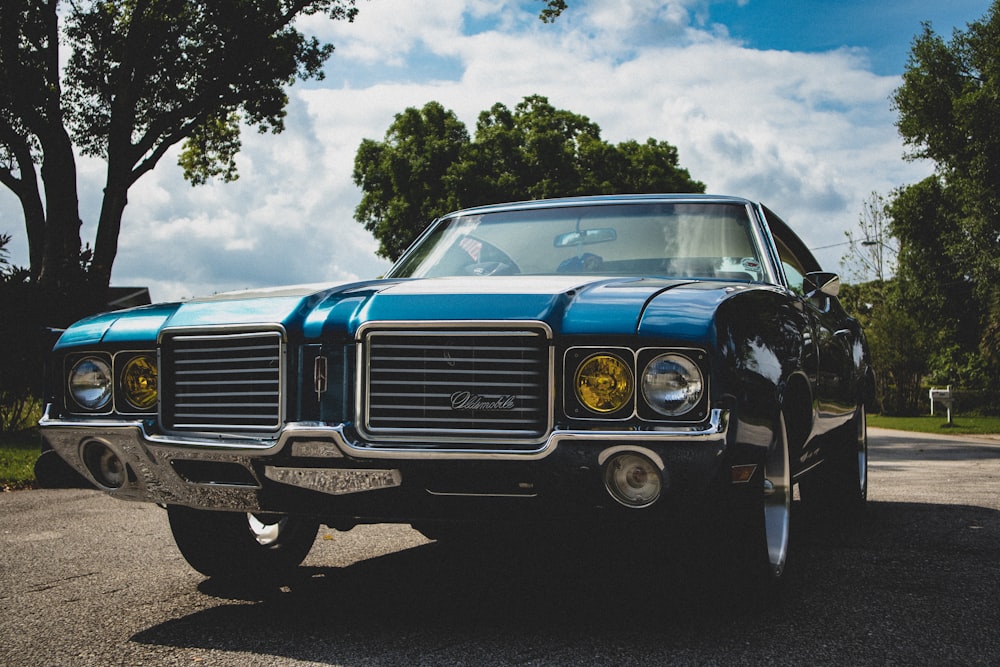 blue and black car on road during daytime