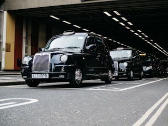 black mercedes benz g class suv parked on gray concrete road during daytime
