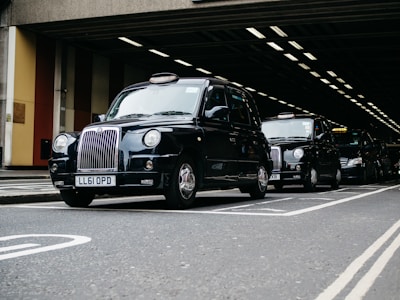 black mercedes benz g class suv parked on gray concrete road during daytime