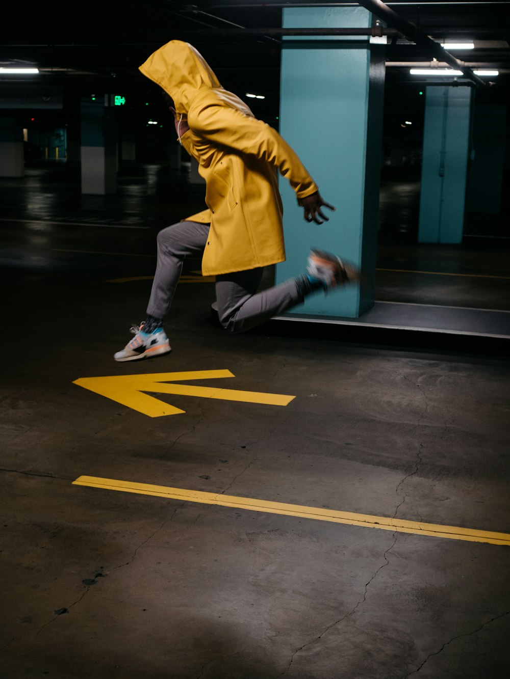 man in yellow long sleeve shirt and white pants walking on sidewalk