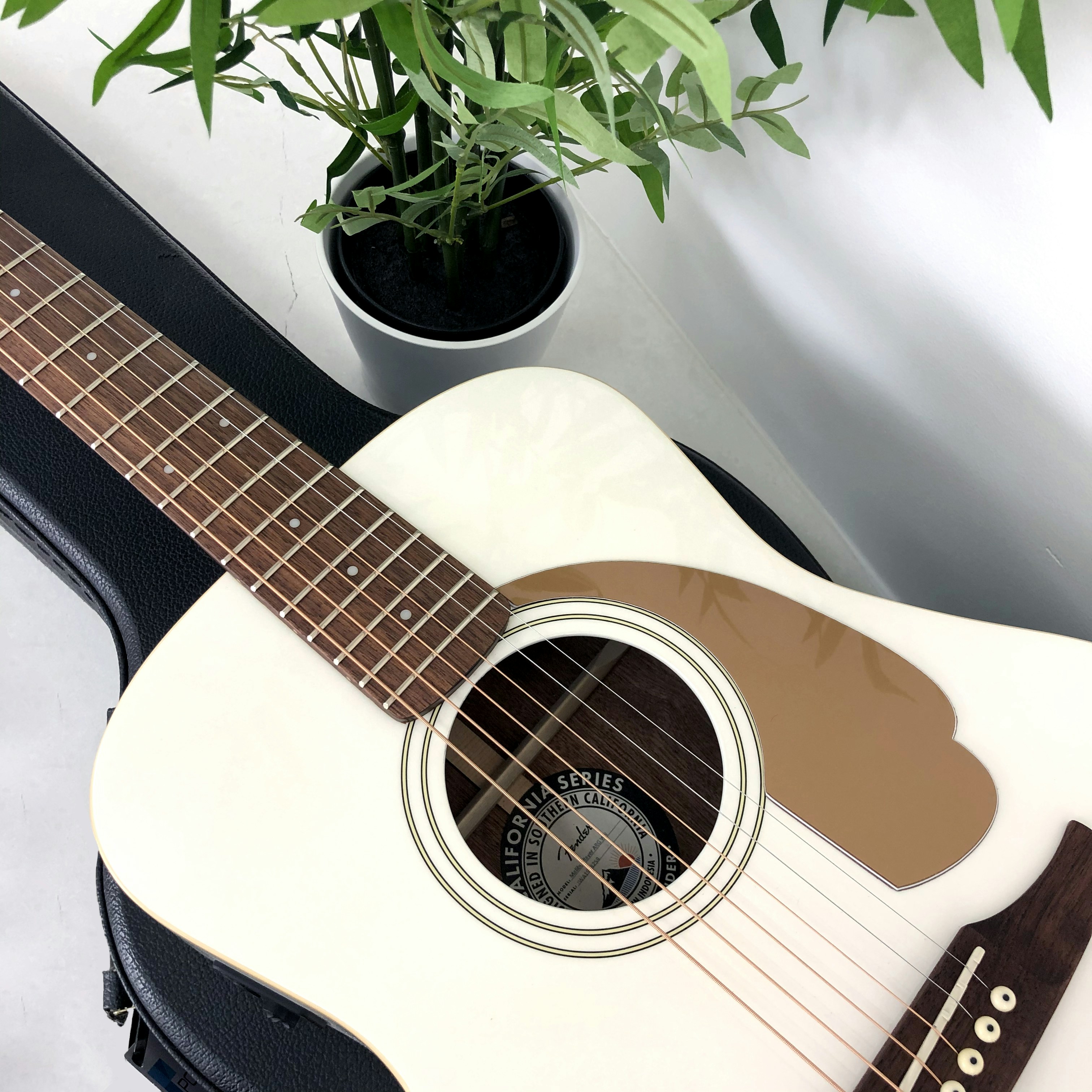 white and black acoustic guitar