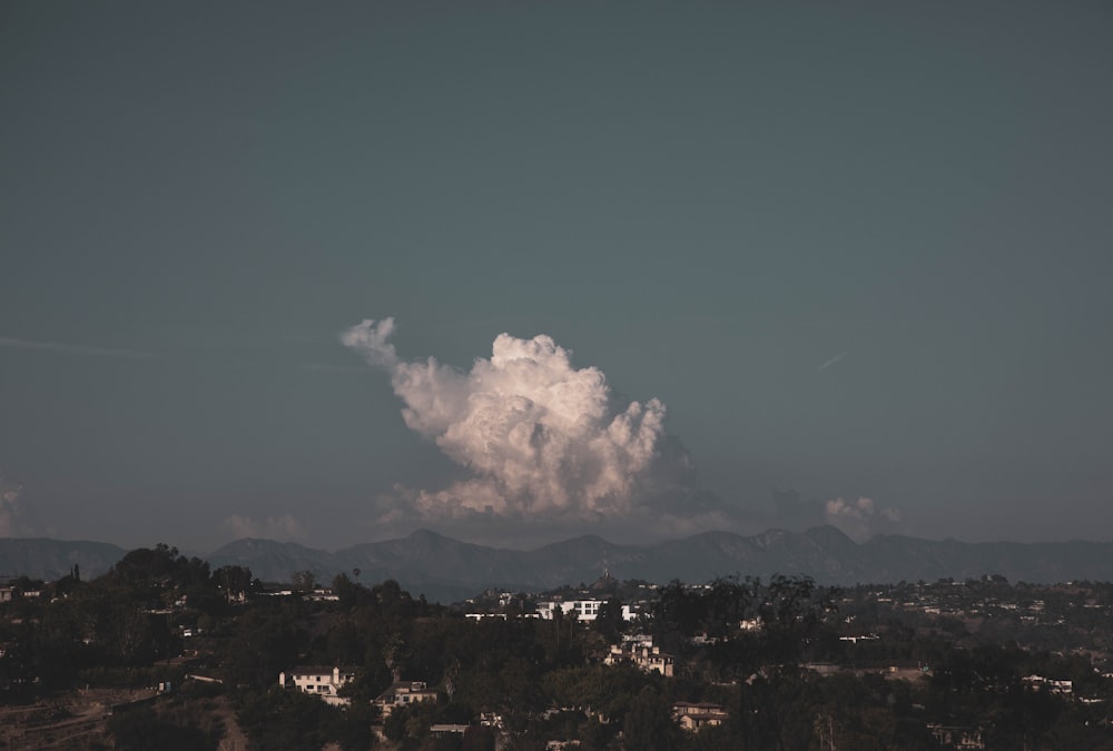 white clouds over city during daytime