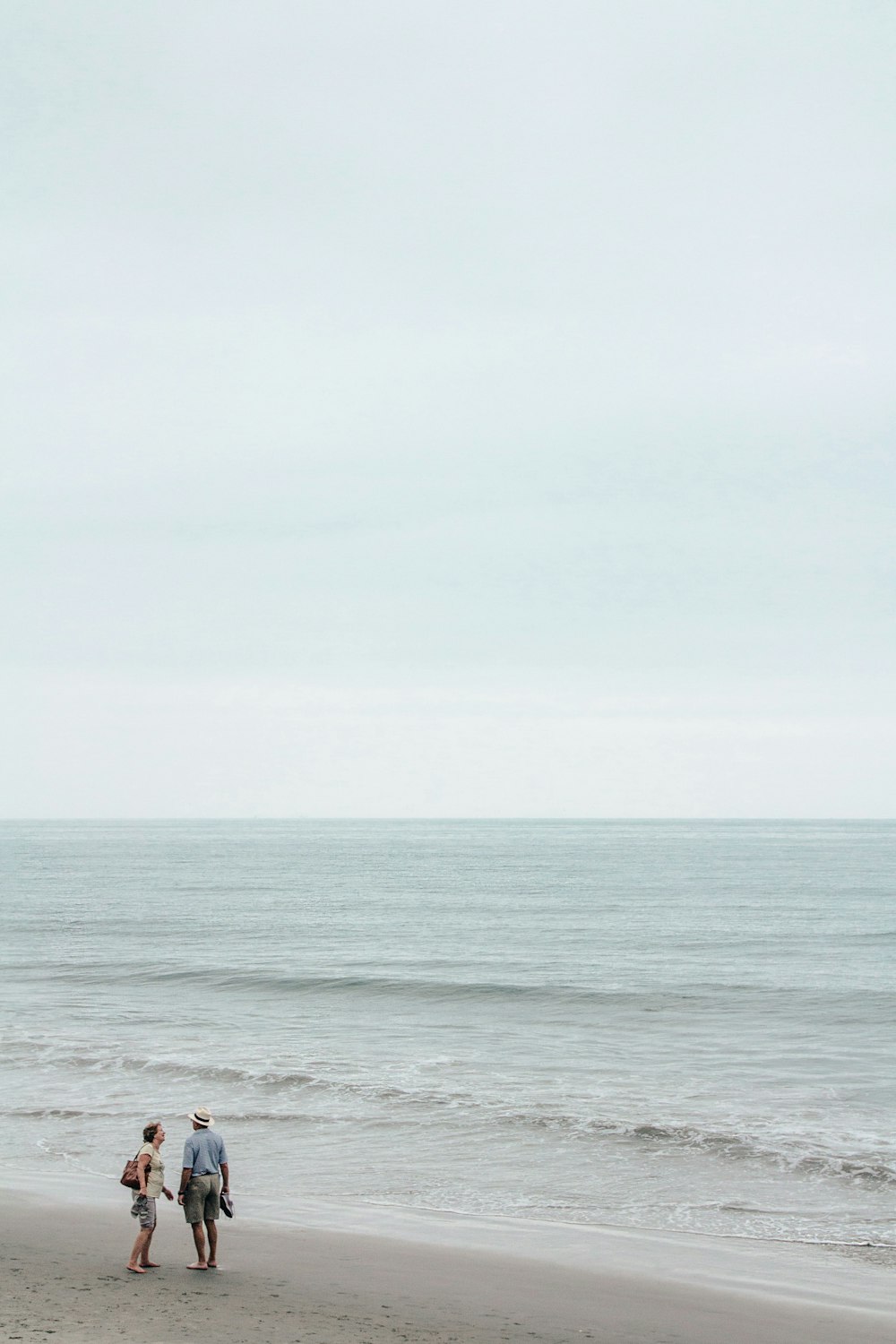 body of water under white sky during daytime