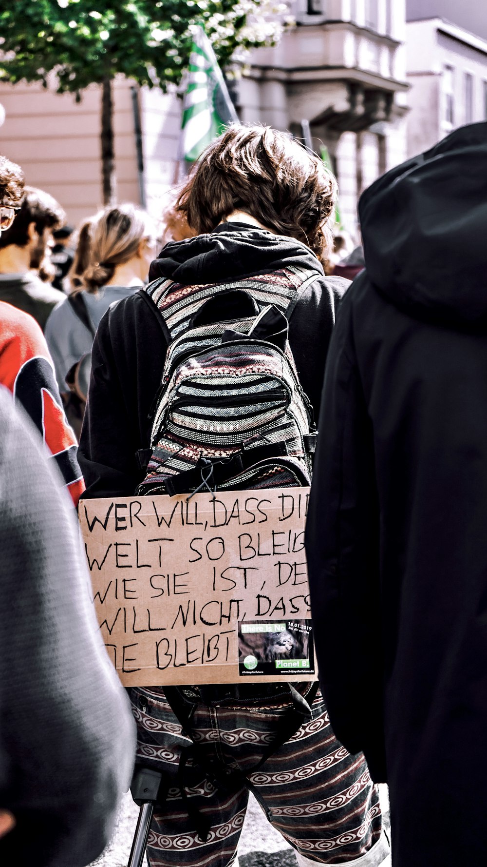 woman in black and white shirt standing near people during daytime