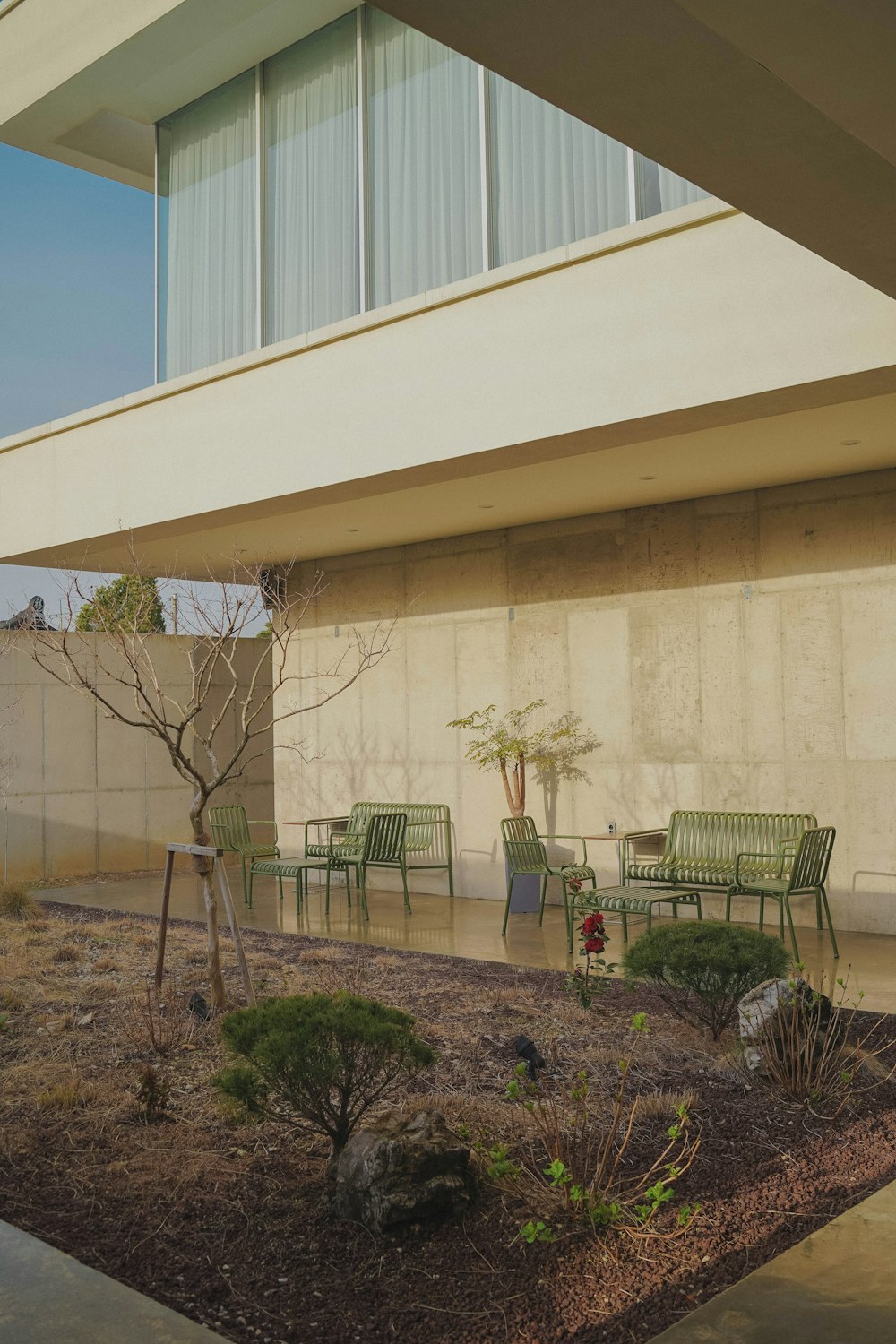 white concrete building with black metal fence