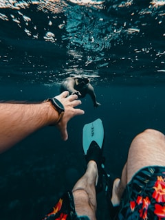 person wearing black and white flip flops