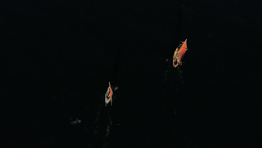 red and yellow boat on water during nighttime