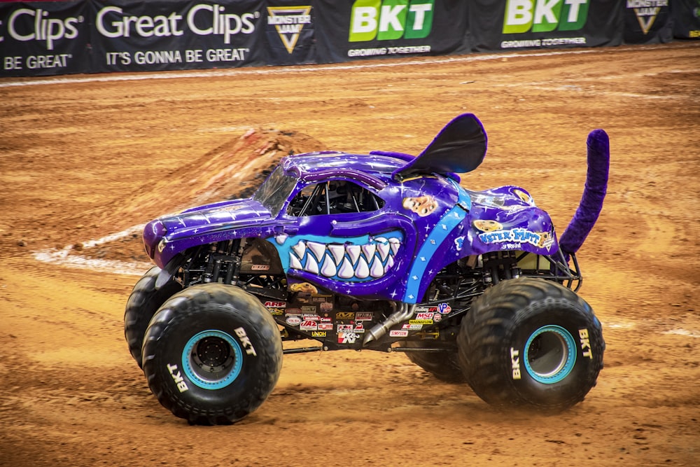 purple and black monster truck on brown sand
