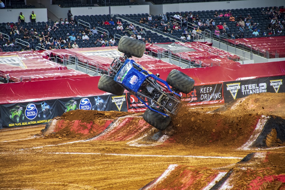 man riding on red and blue racing car