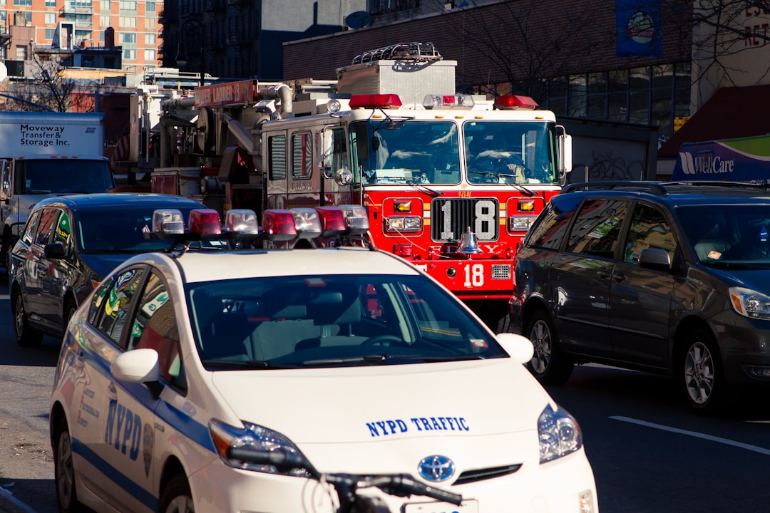 white and red police car on road during daytime,
