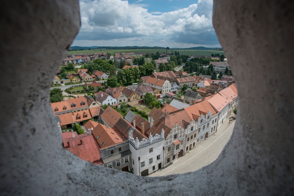 white and brown concrete houses under white clouds during daytime