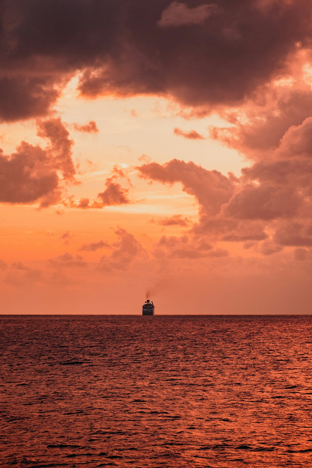 silhouette of person standing on dock during sunset