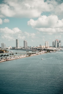 city skyline under white clouds and blue sky during daytime