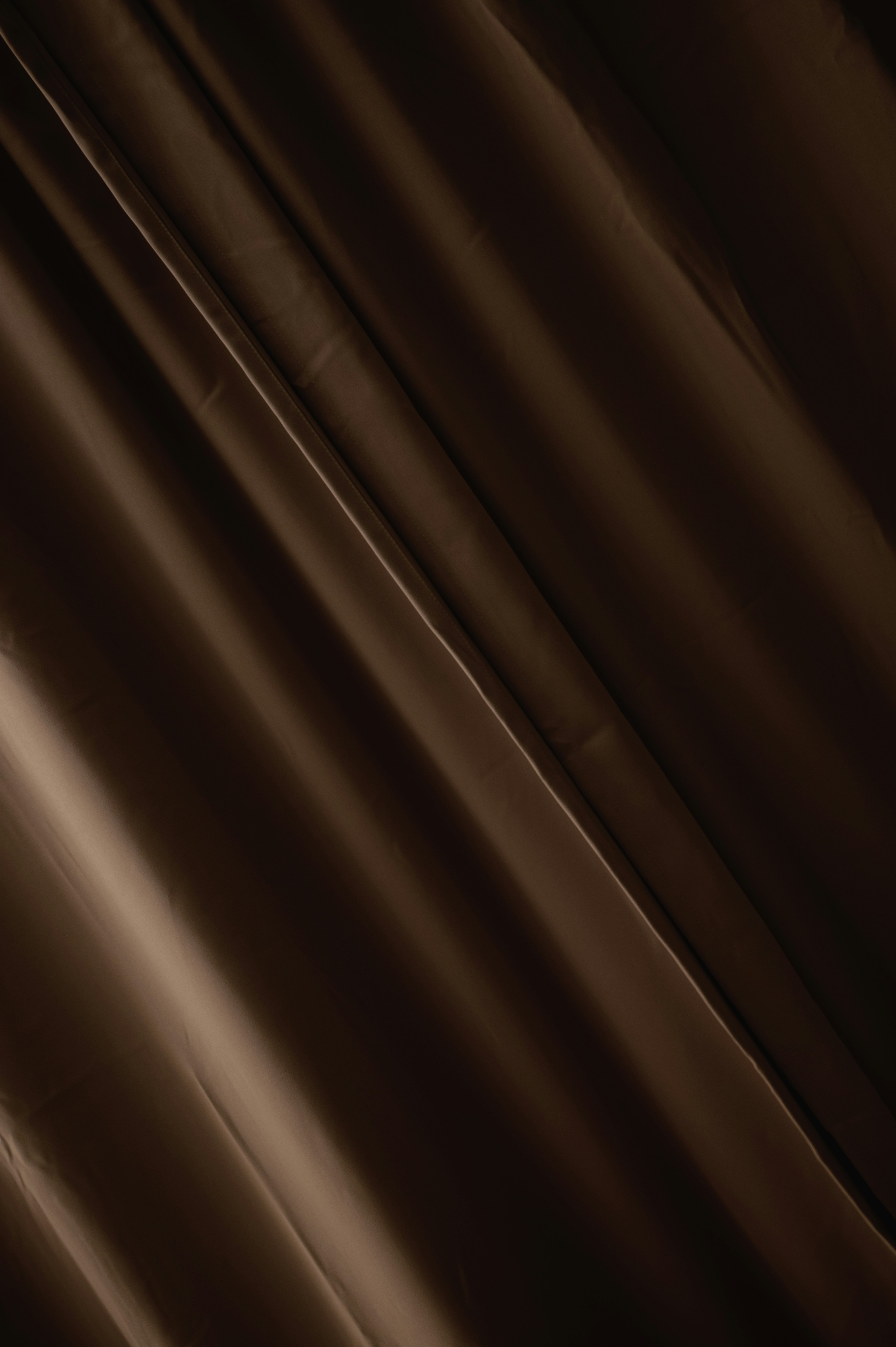 brown window curtain in close up photography