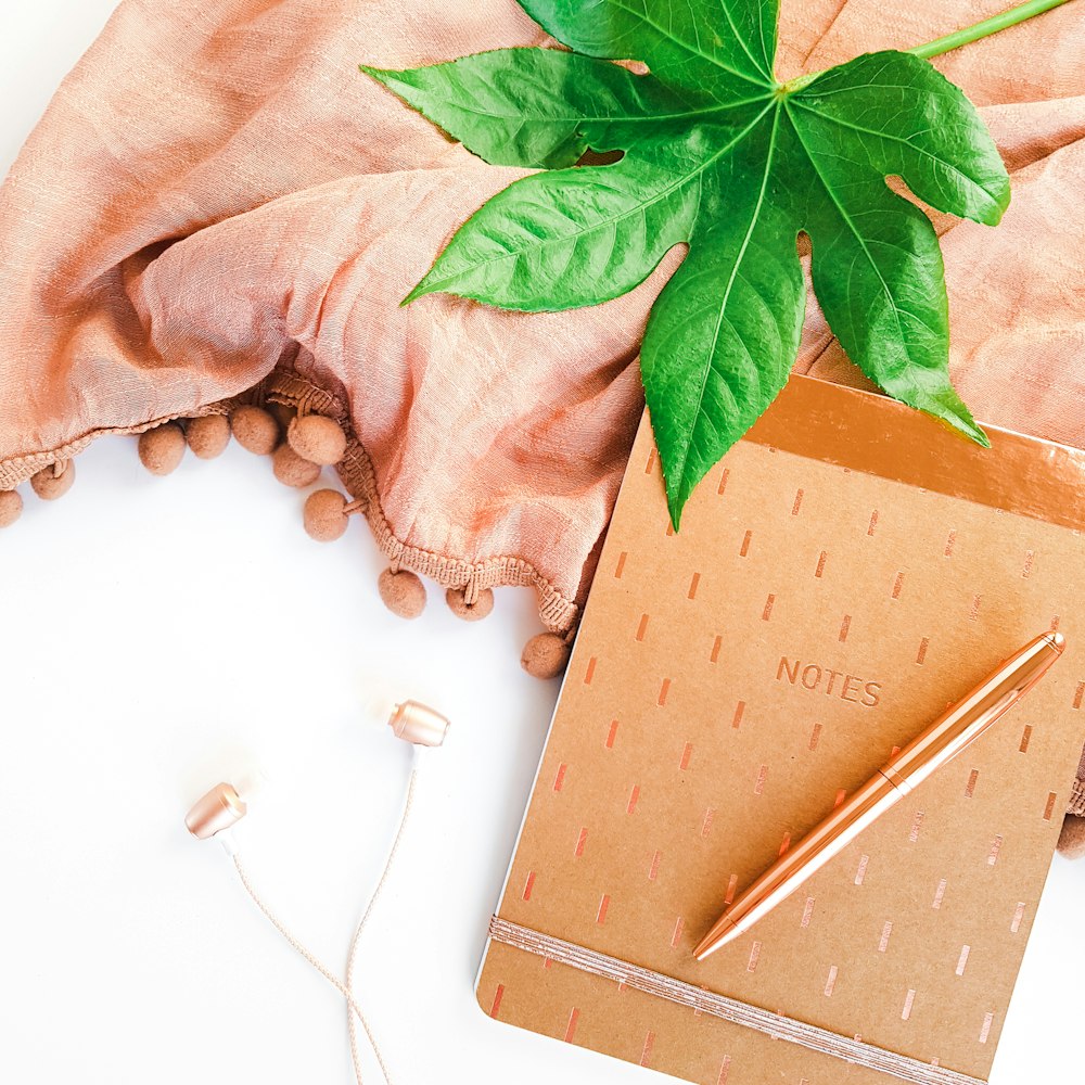 brown book with green leaves