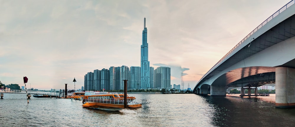 brown boat on water near city buildings during daytime