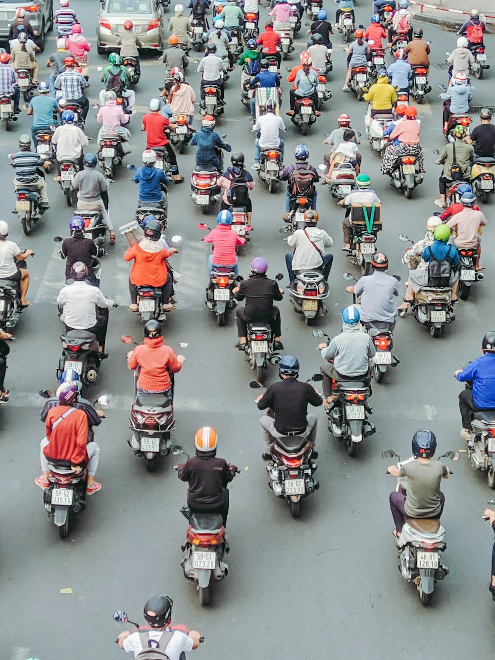 people riding motorcycle on road during daytime