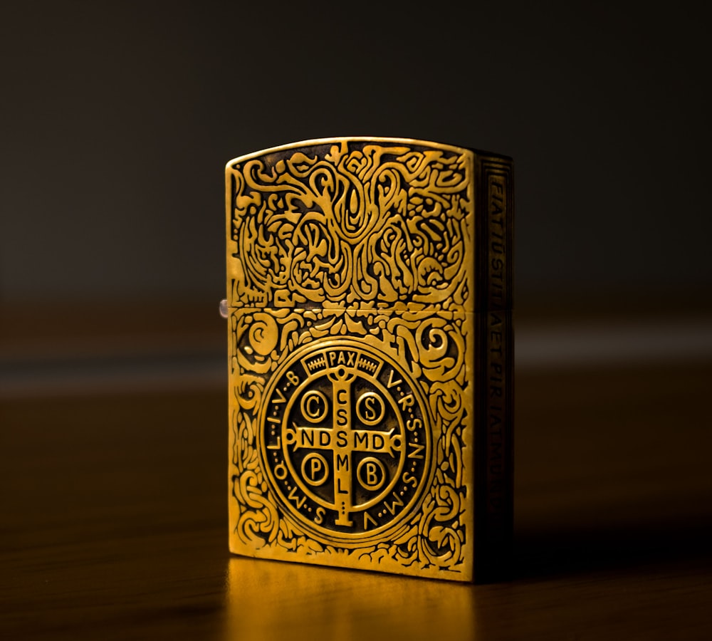 gold and black floral flip lighter