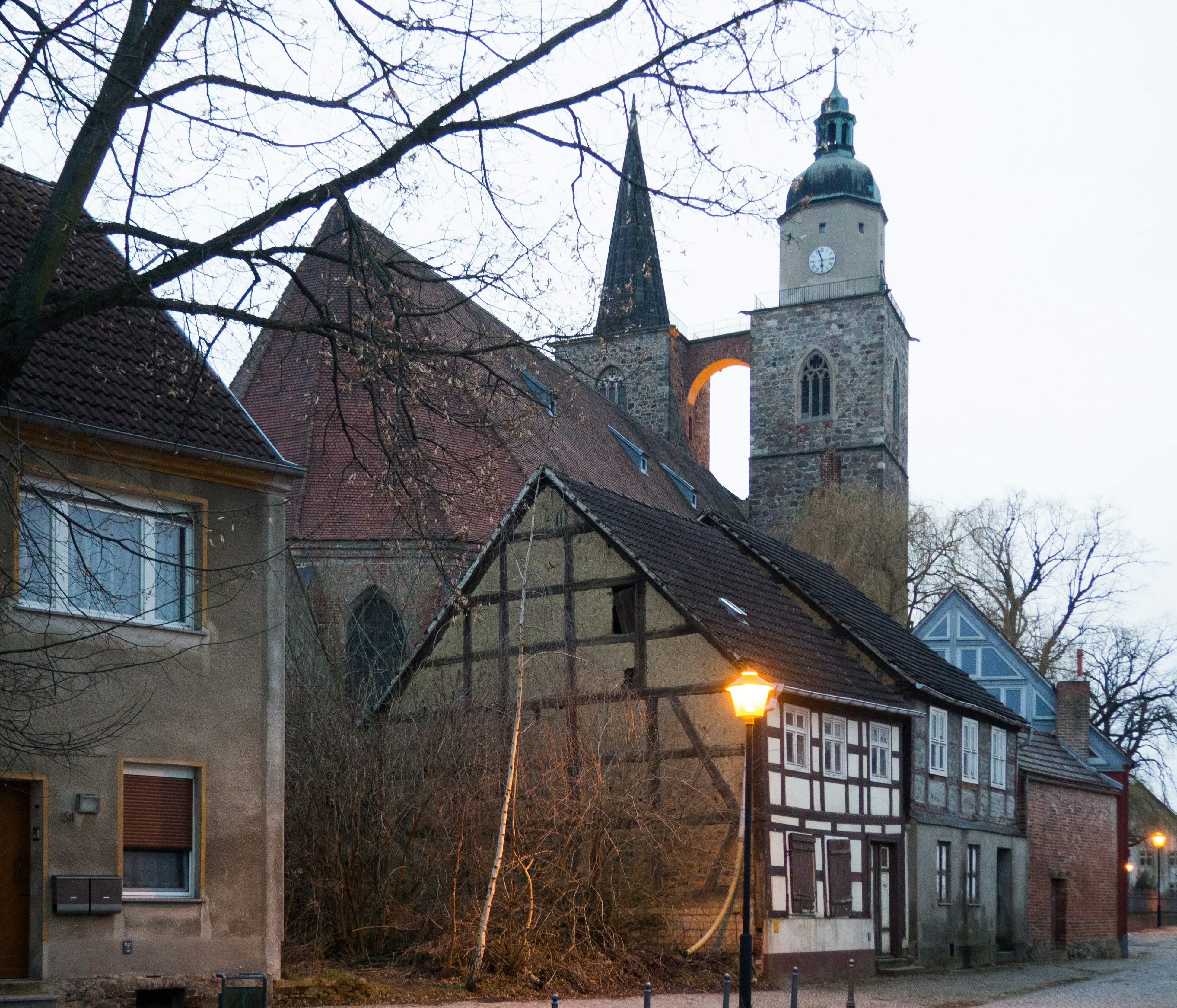 brown and gray concrete building near bare trees during daytime