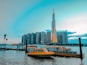 white and brown boat on water near city buildings during daytime