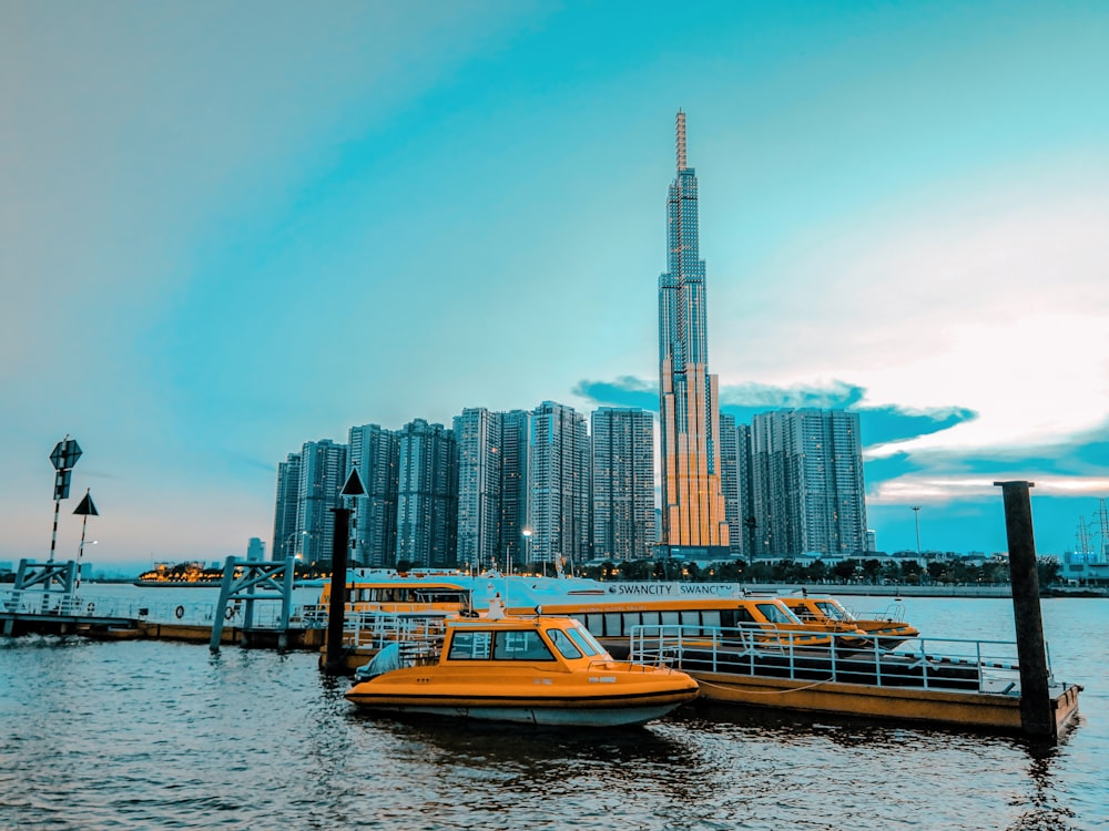 white and brown boat on water near city buildings during daytime