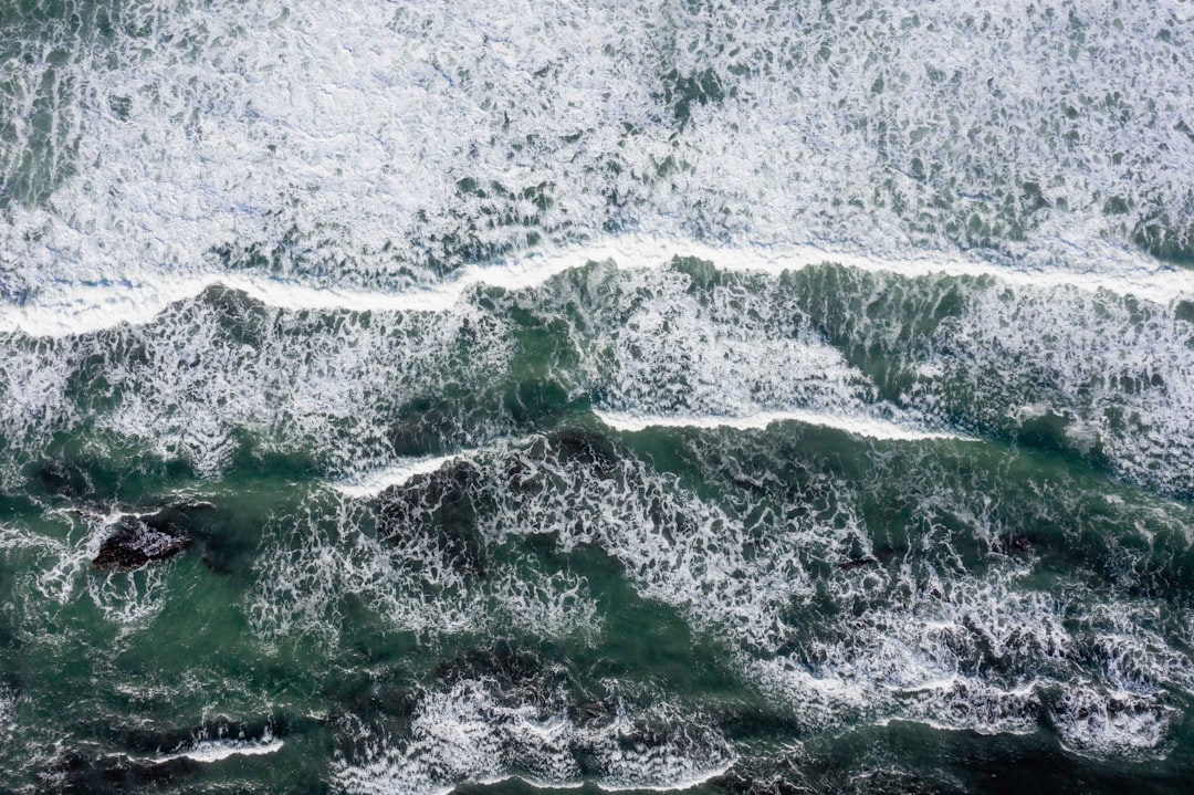 aerial view of green and white ocean waves