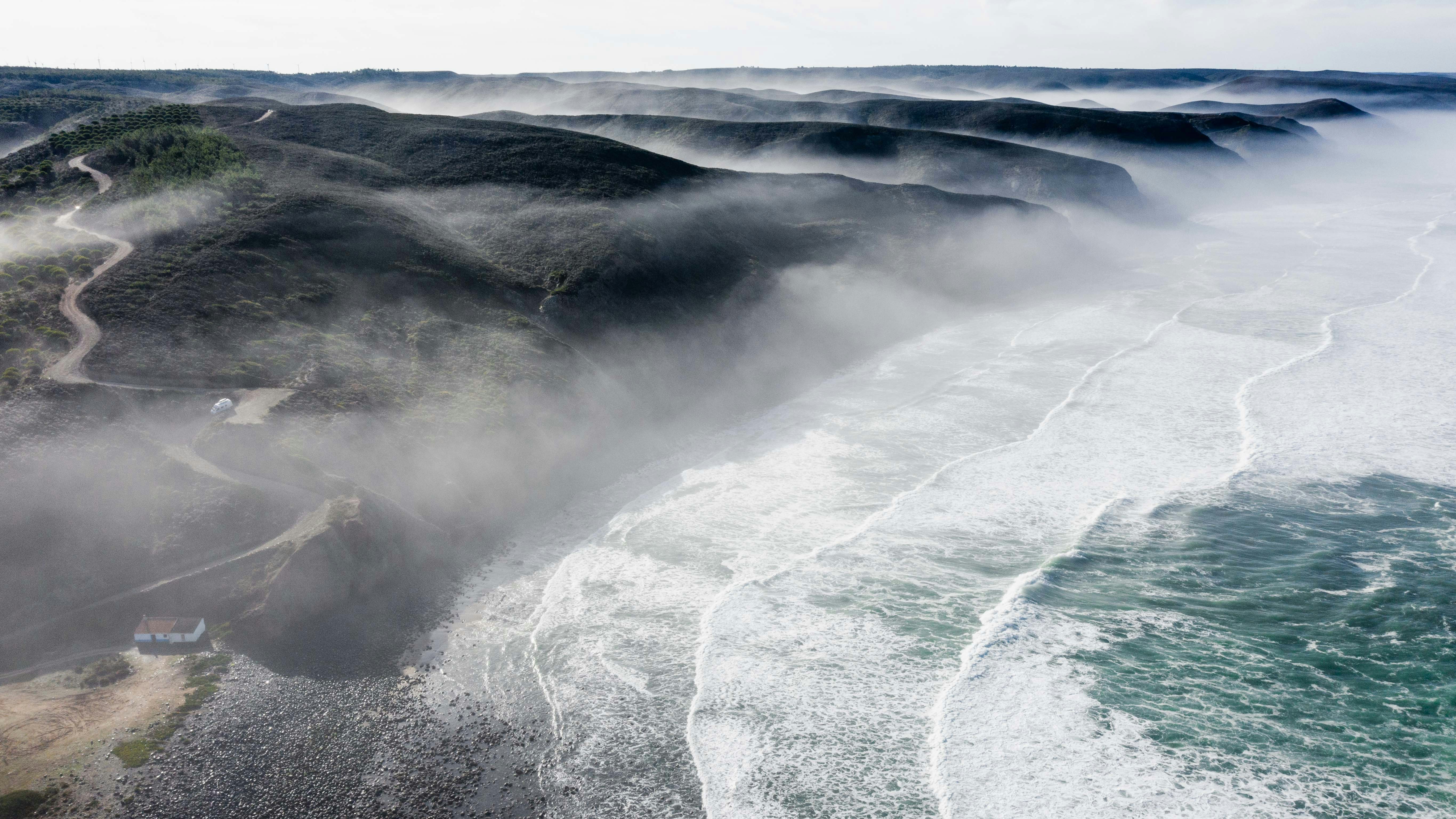 ocean waves crashing on shore during daytime