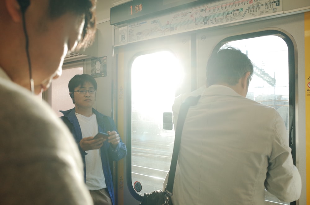 man in white dress shirt standing beside man in white dress shirt