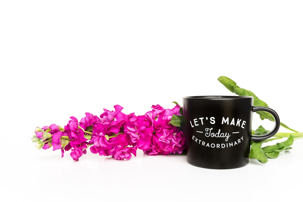 purple flowers on black ceramic mug