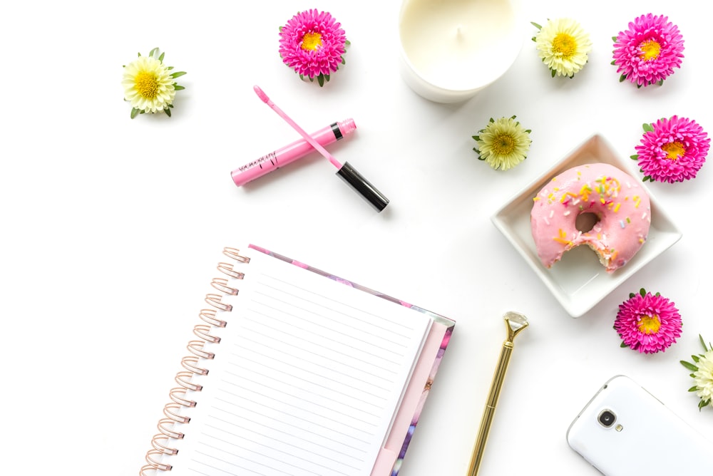 pink pen on white notebook