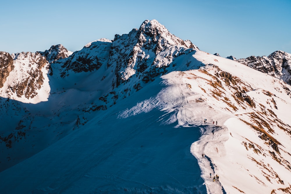 snow covered mountain under blue sky during daytime